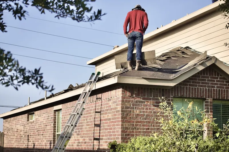 Professional roofer working on a residential roof in Braddock Heights